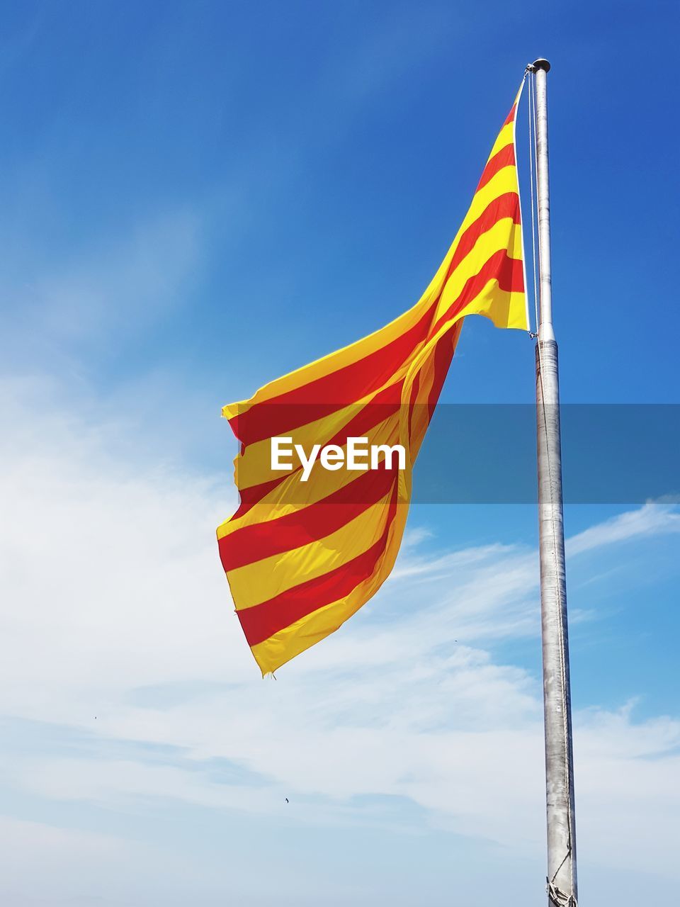 Low angle view of spanish flag against sky