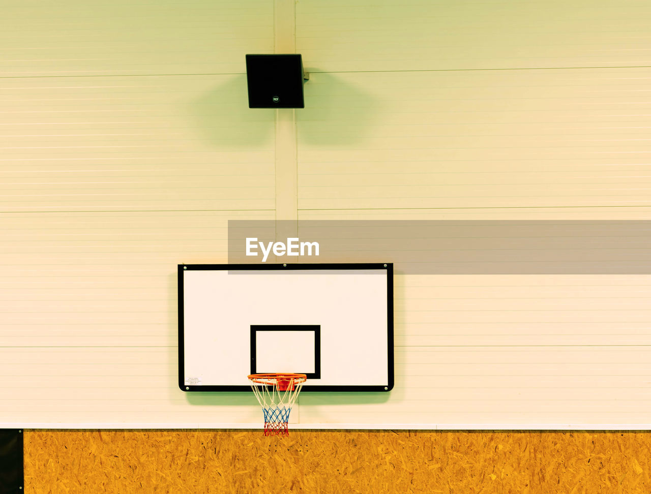 School gym with basketball board and basket. basketball hoop in the high school gym