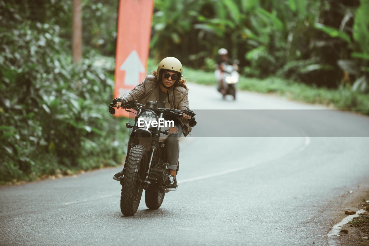 Man riding motorcycle on road