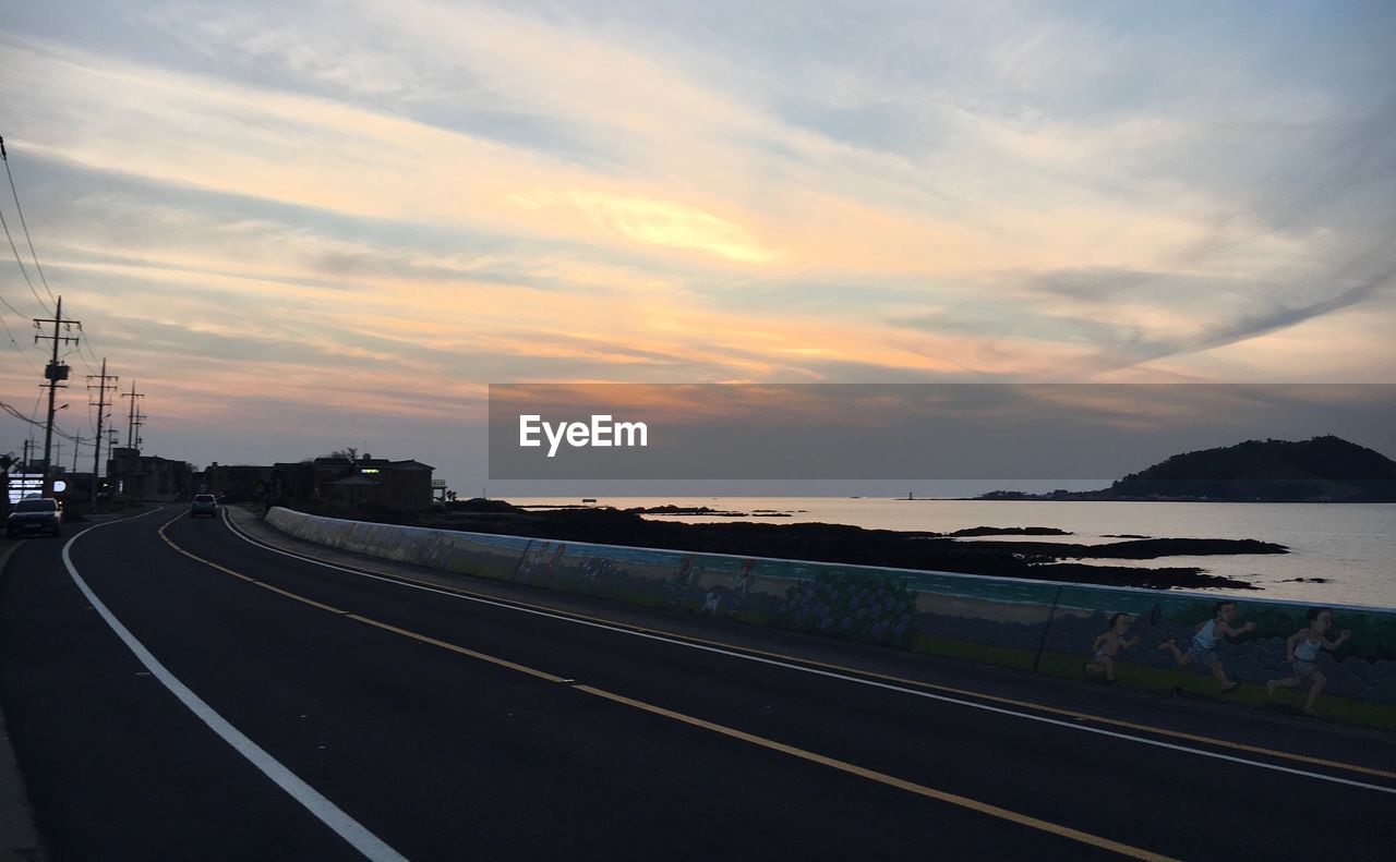 SCENIC VIEW OF ROAD AGAINST SKY DURING SUNSET