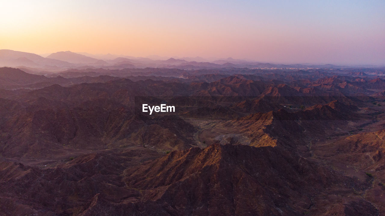 Aerial view of dramatic landscape during sunset
