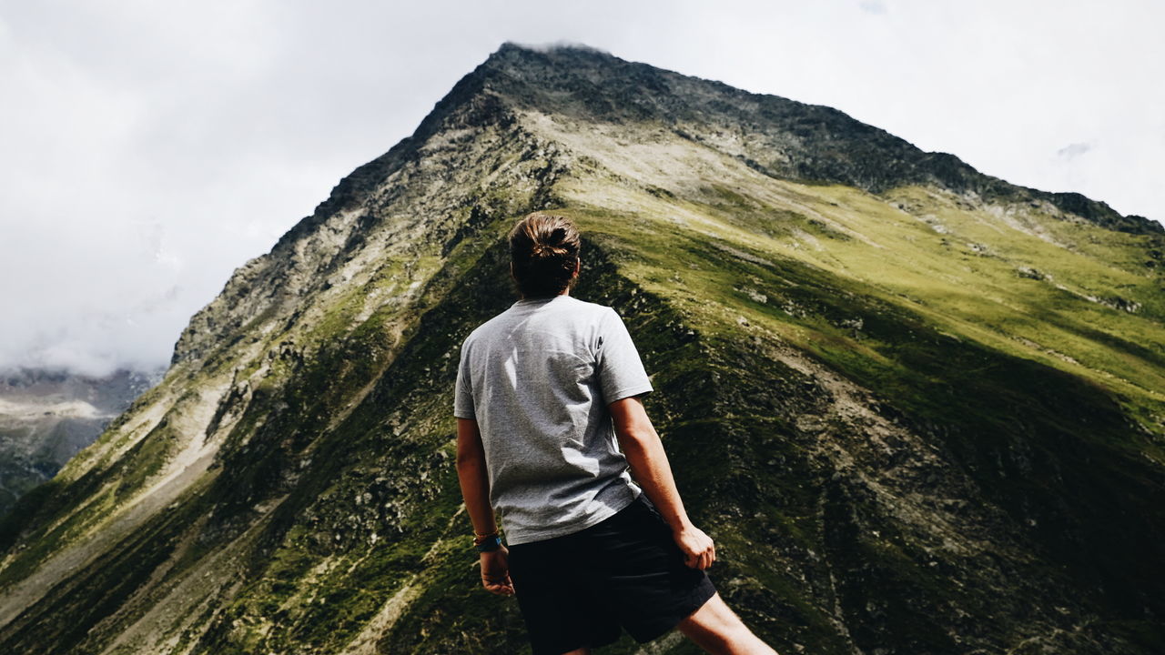 Man standing on mountain against sky