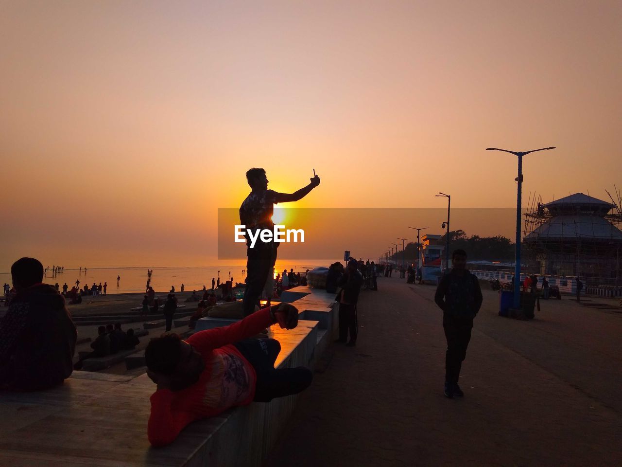 PEOPLE ON BEACH DURING SUNSET