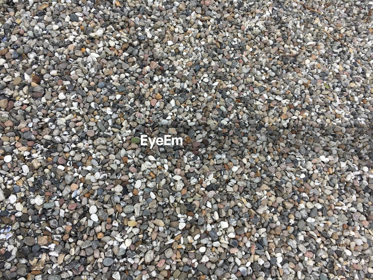 CLOSE-UP OF PEBBLES ON BEACH