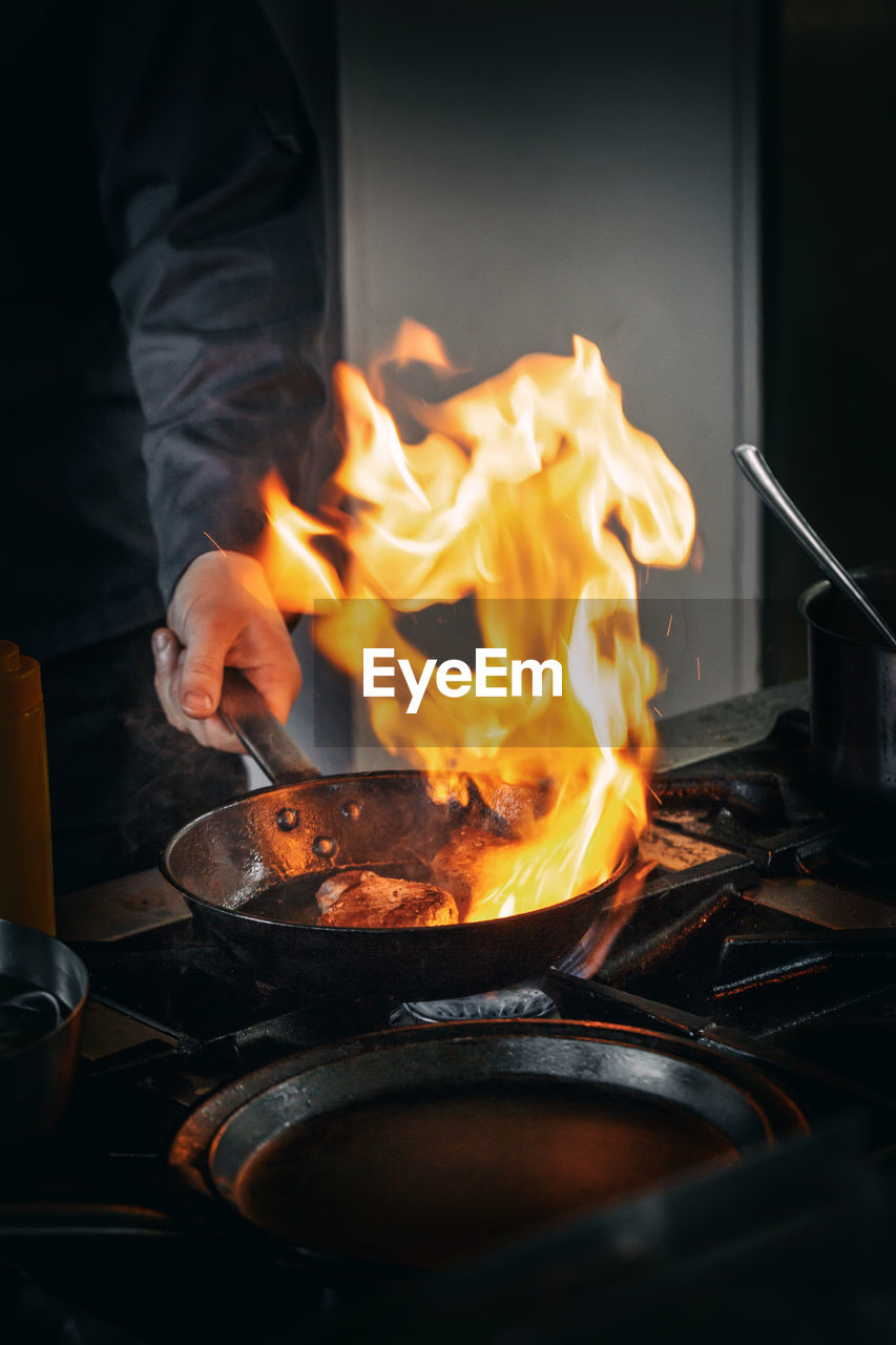 cropped image of man preparing food on barbecue grill