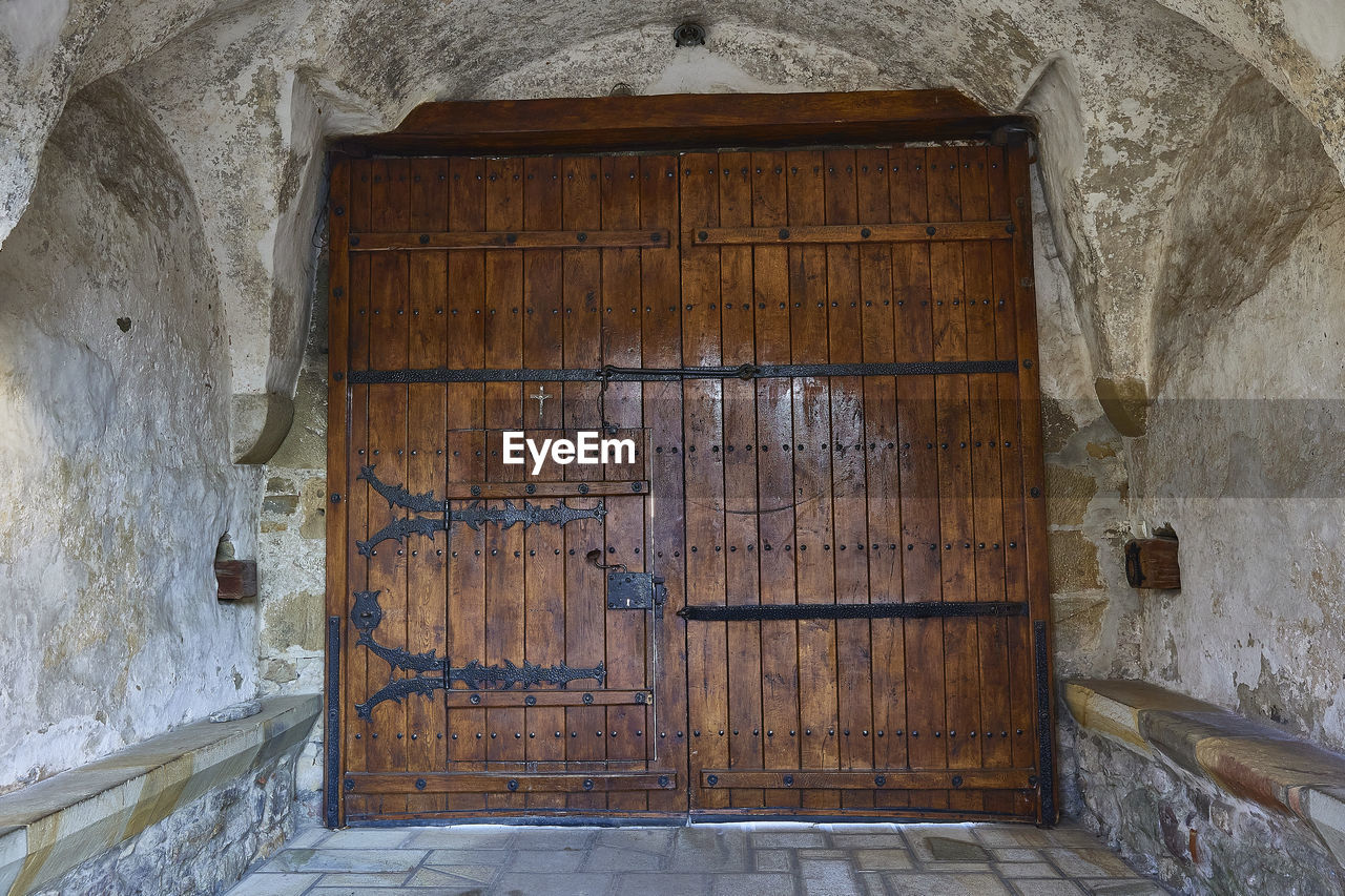 architecture, entrance, door, built structure, building, history, building exterior, no people, old, closed, the past, house, wall - building feature, ancient history, wood, wall, security, day, protection, place of worship, window, doorway, ancient, outdoors, arch, weathered, residential district, abandoned