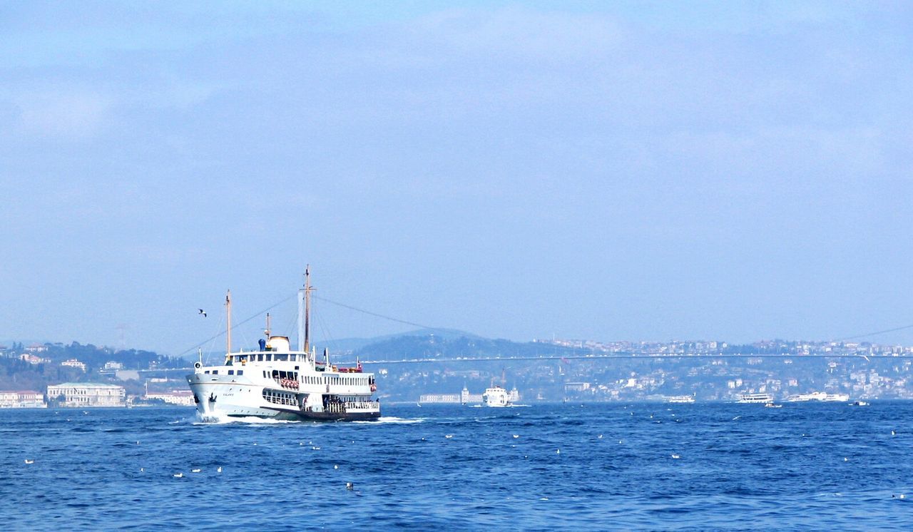 Ship sailing on sea against sky