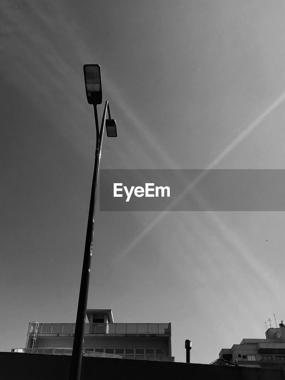 Low angle view of street light against building