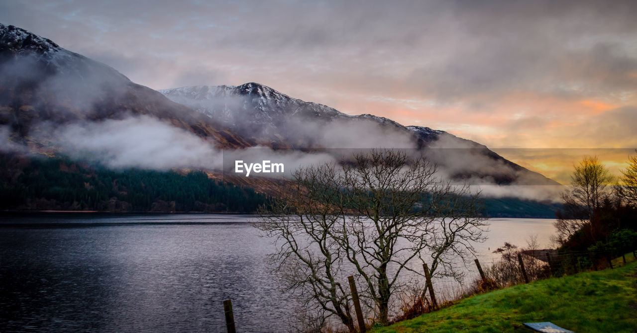 Scenic view of lake and mountains against sky