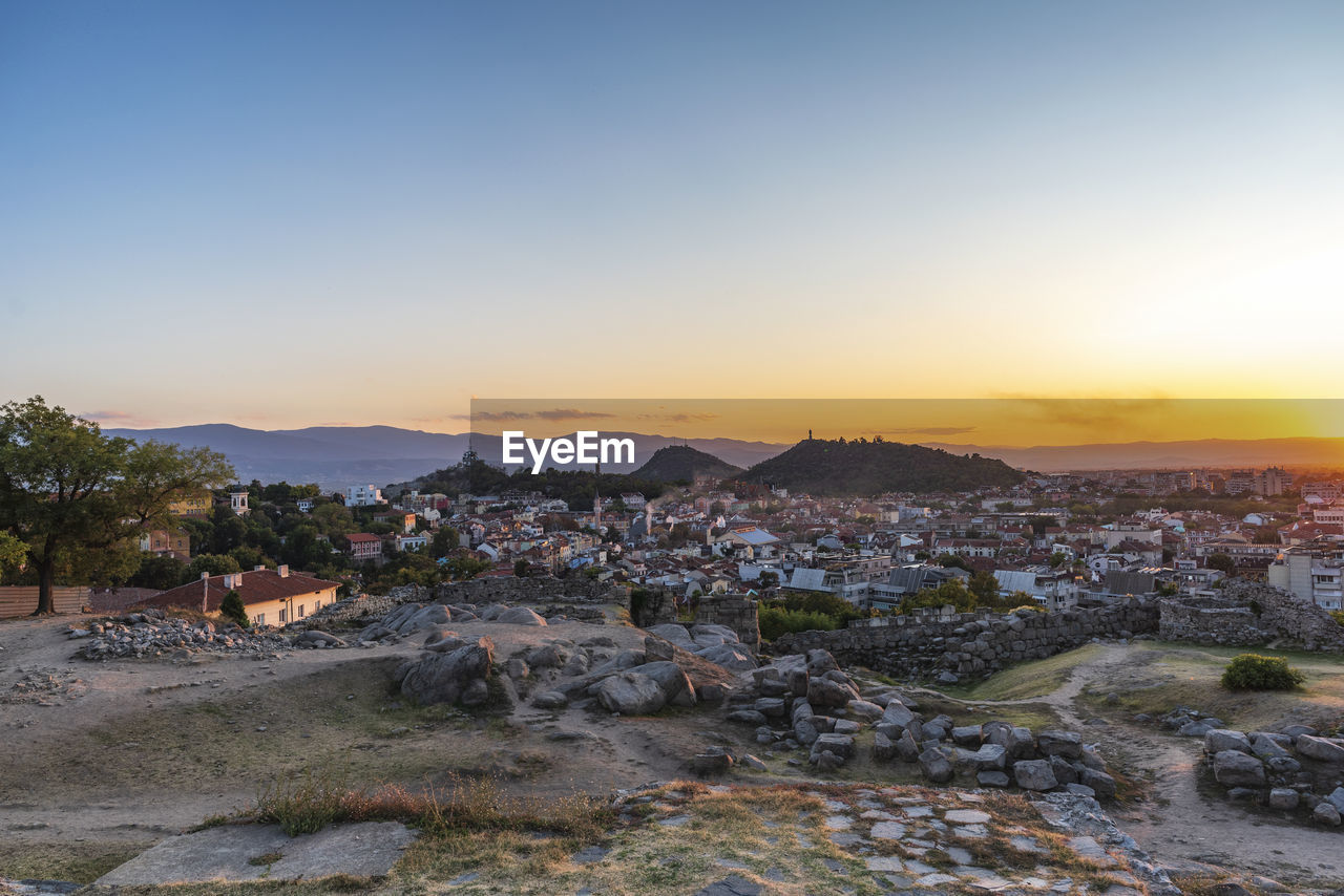 Townscape against sky during sunset