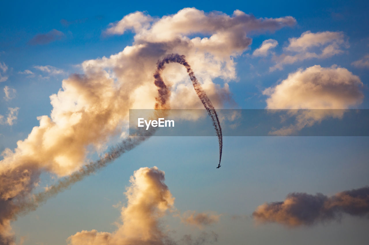 Low angle view of vapor trail against sky