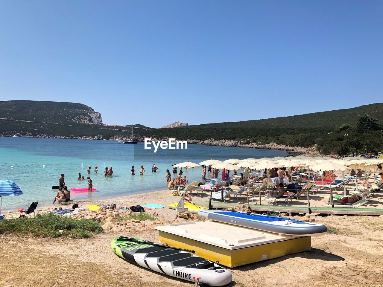 PEOPLE AT BEACH AGAINST CLEAR SKY