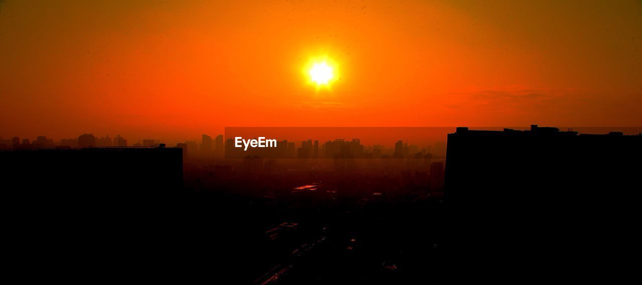 SILHOUETTE OF BUILT STRUCTURE AT SUNSET