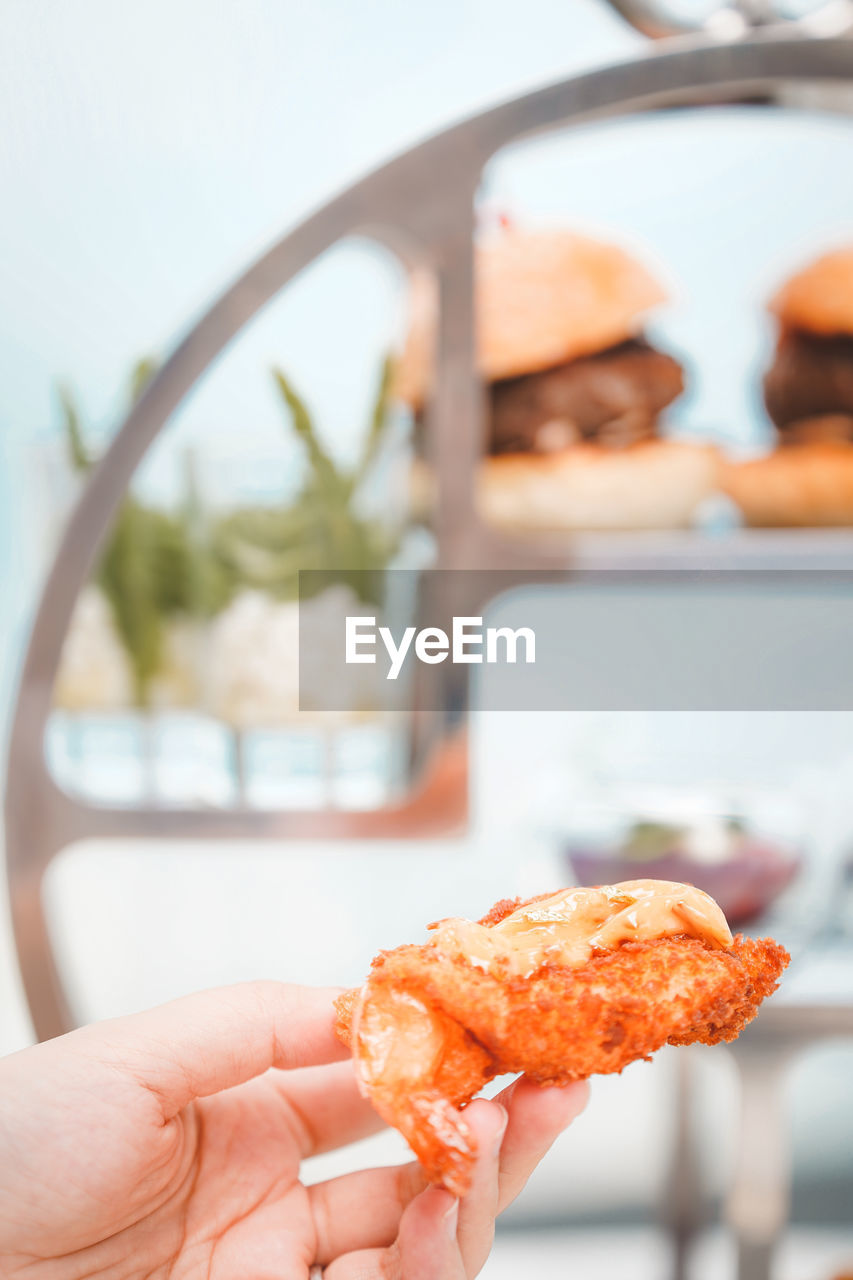 cropped hand of person holding food