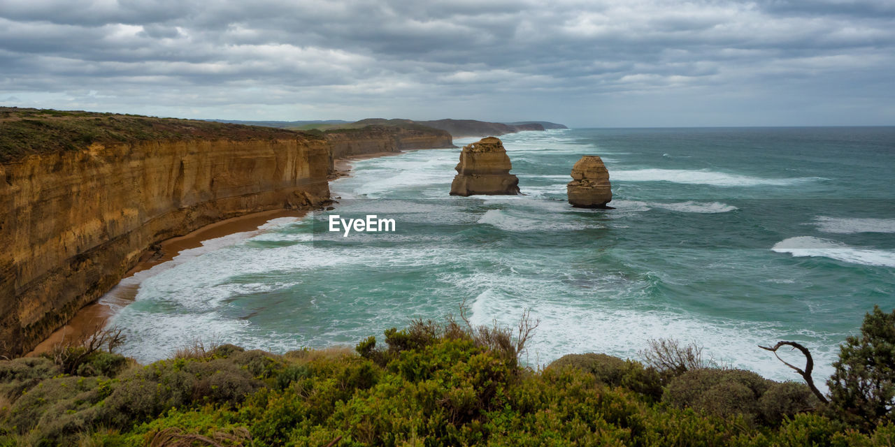 SCENIC VIEW OF ROCK FORMATION IN SEA AGAINST SKY