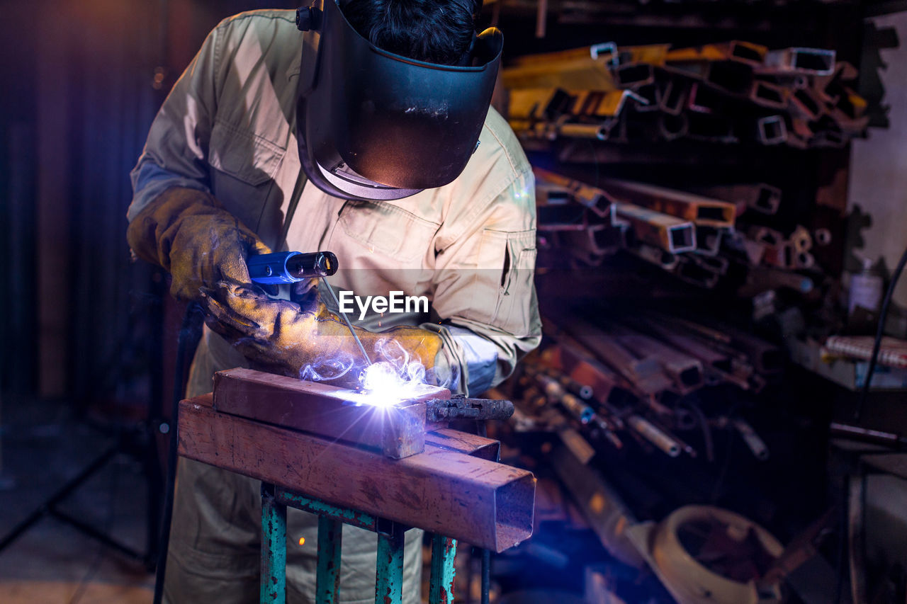 Welder welding in workshop