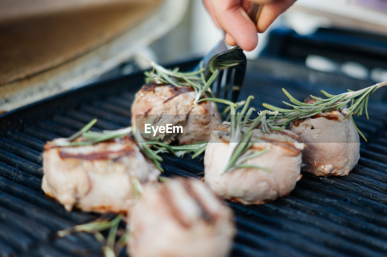 Grilled meat with rosemary on top while being prepared