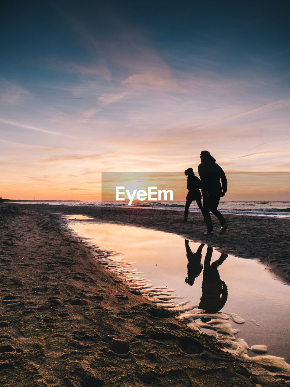 Silhouette of young couple on beach