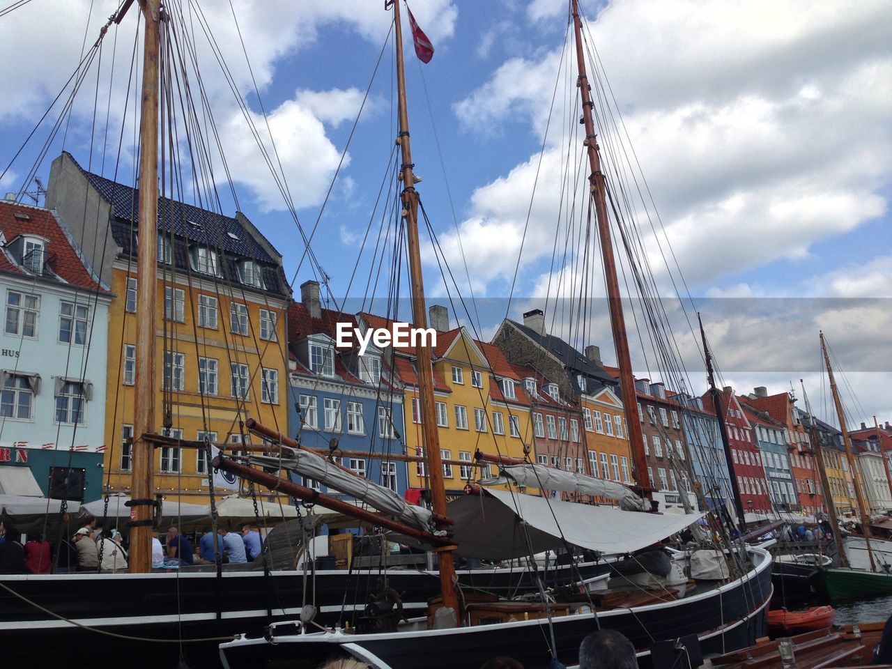 Boats moored in canal by buildings in city