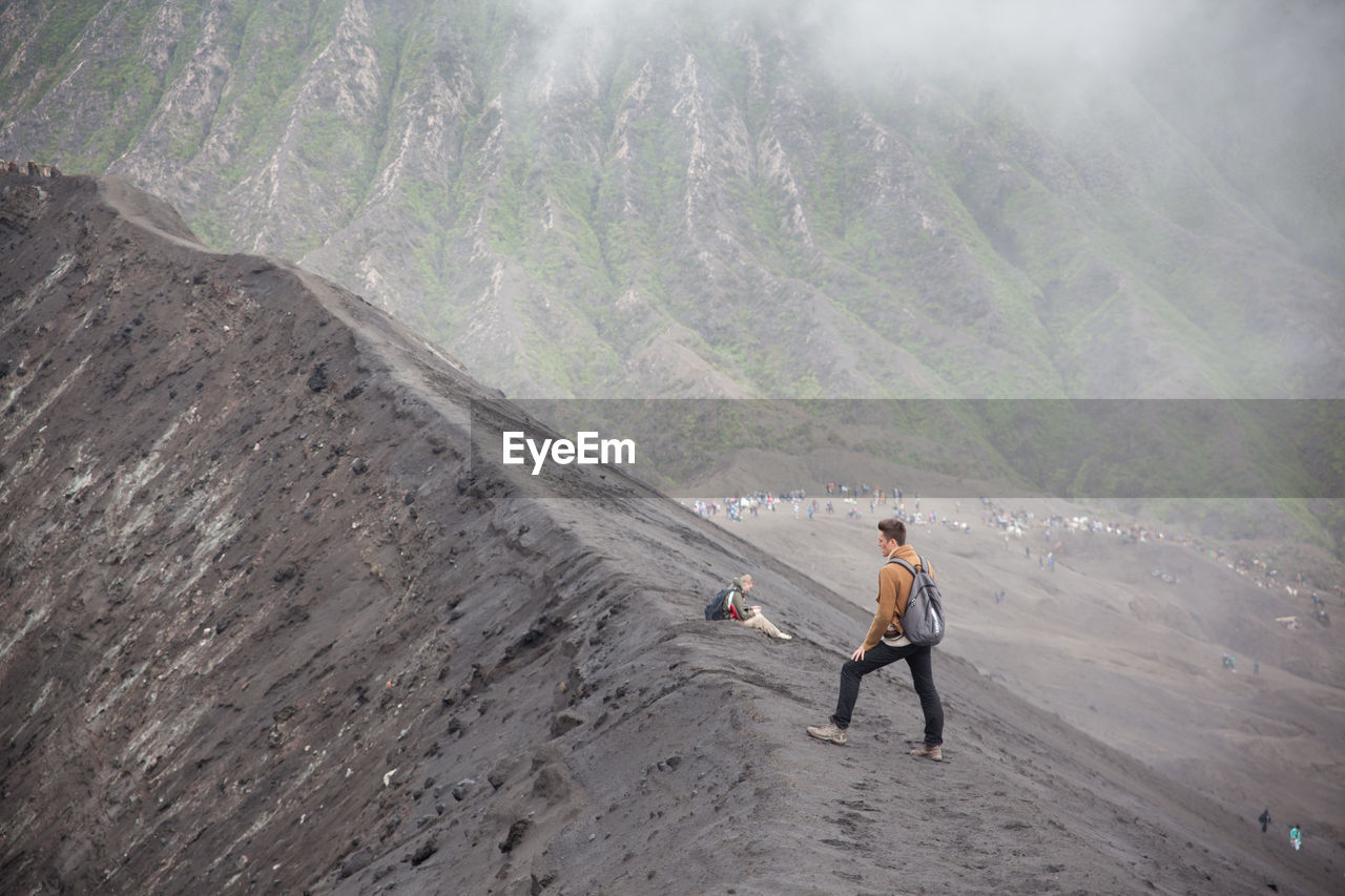 High angle view of man standing on volcanic mountains