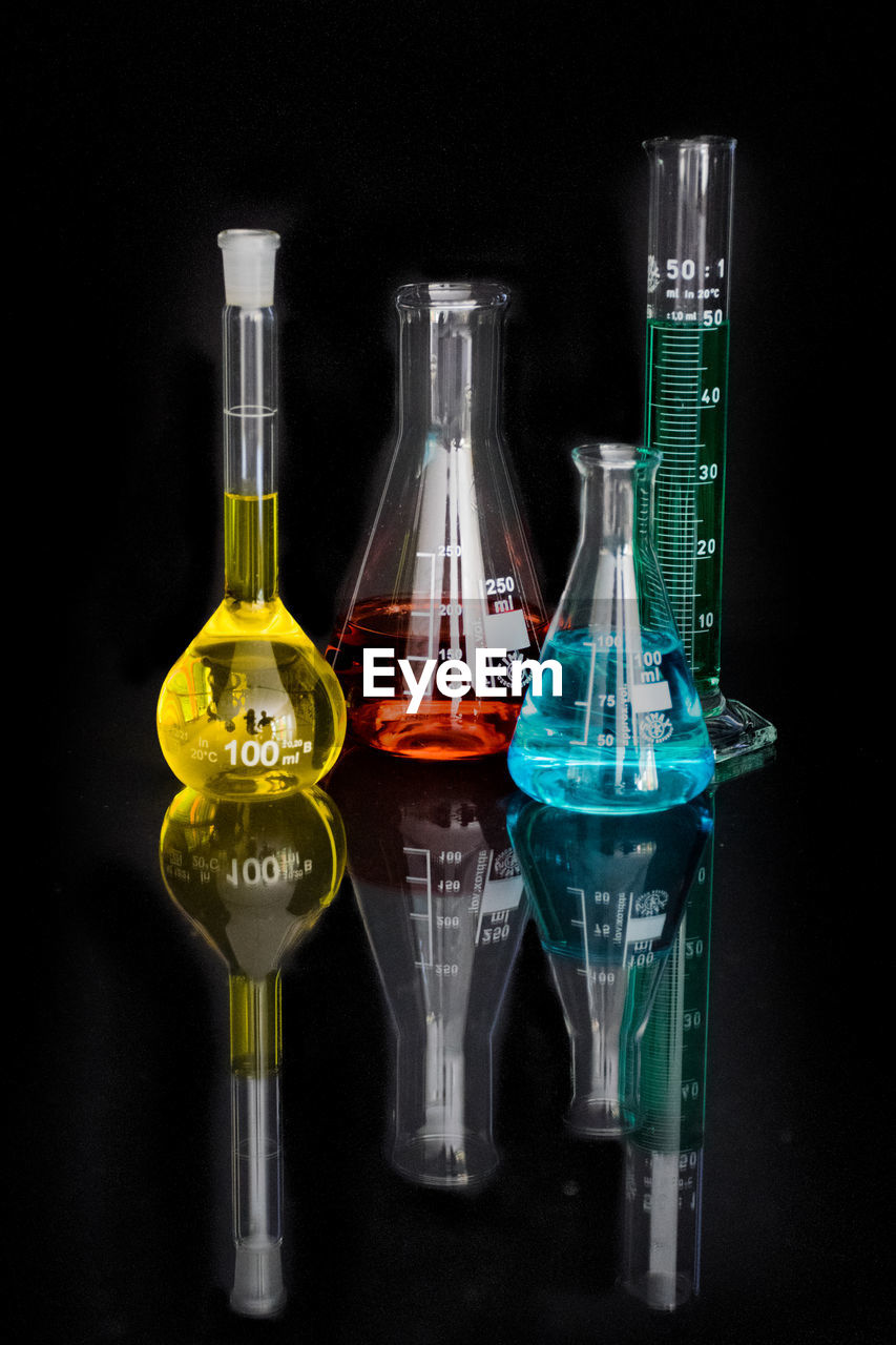 Test tubes and beakers with colorful liquids in laboratory