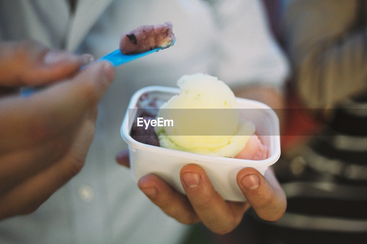 Cropped image of man holding ice cream