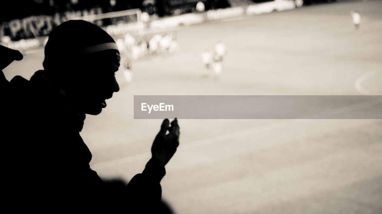 Silhouette man at soccer stadium