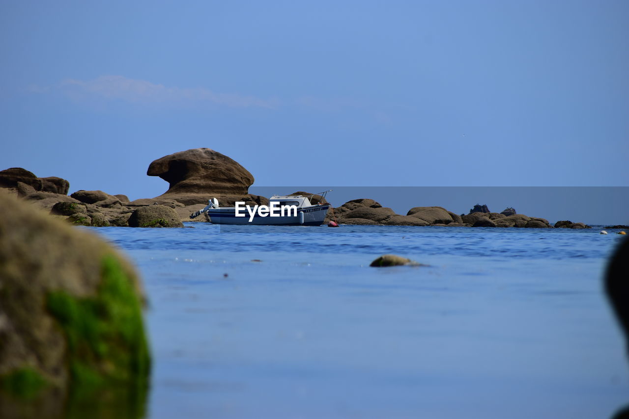 ROCKS IN SEA AGAINST SKY