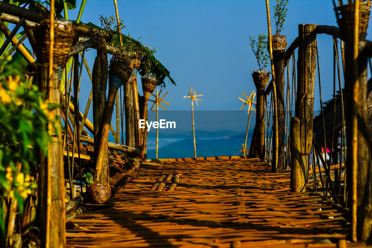 Walkway amidst sea against sky