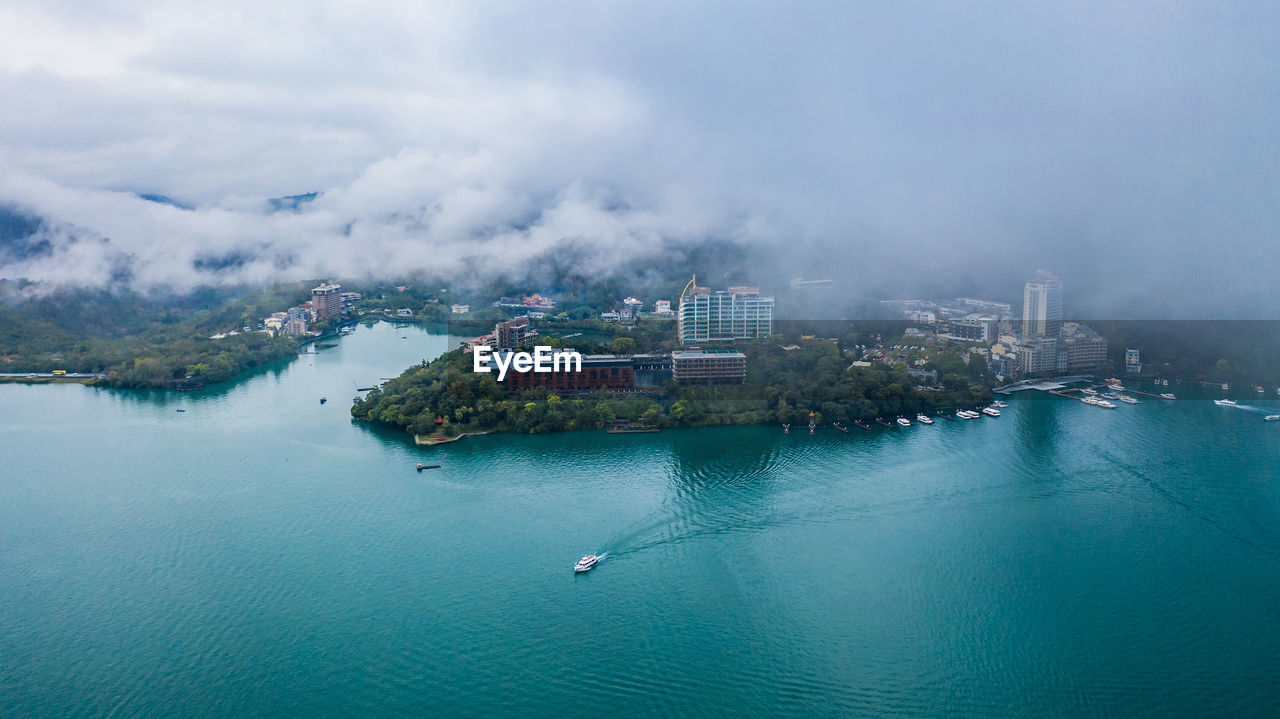 Aerial view of sea against cloudy sky