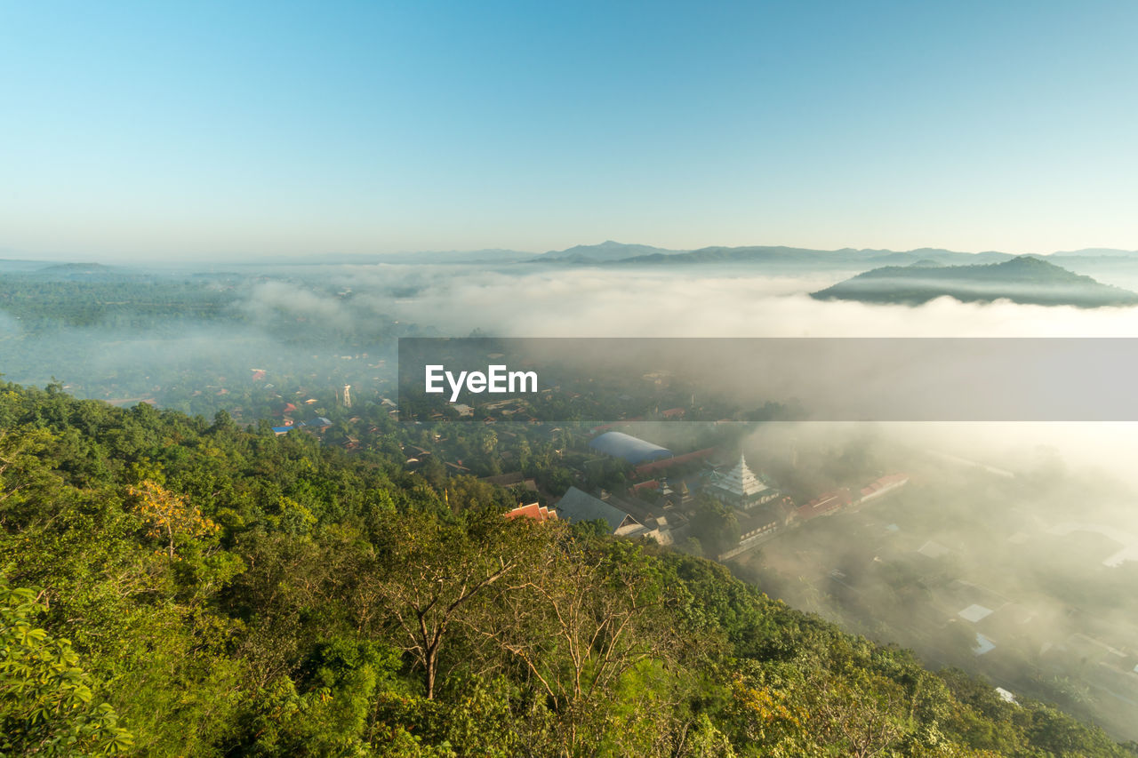 Morning fog covers lamphun, thailand, view from the viewpoint of wat phra that pha temple