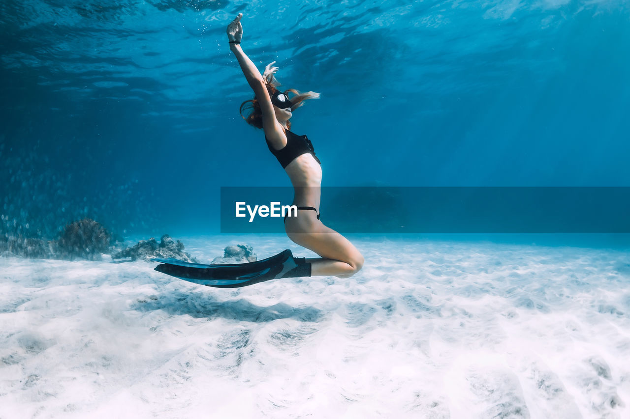 high angle view of woman swimming in sea