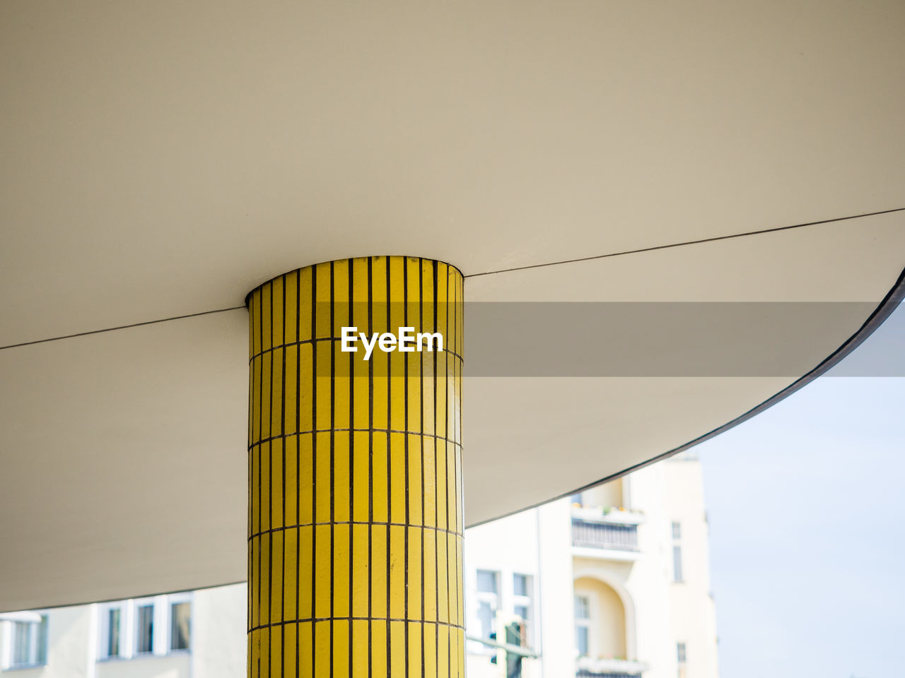 Low angle view of yellow pillar against sky