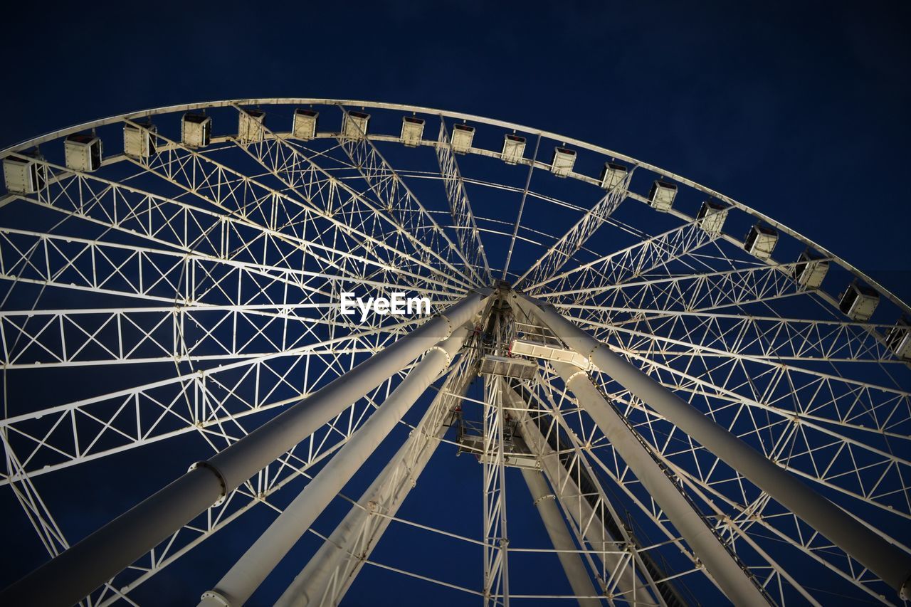 LOW ANGLE VIEW OF FERRIS WHEEL AGAINST SKY AT NIGHT