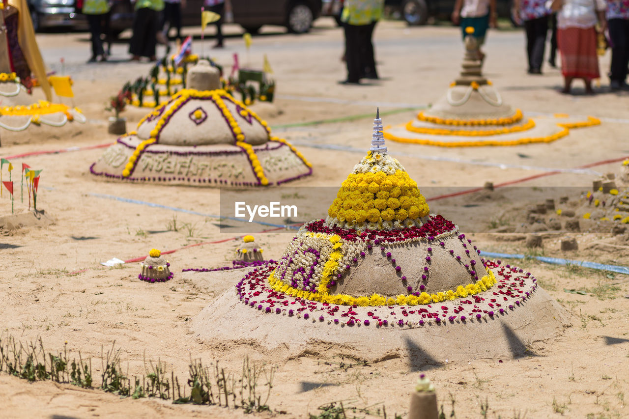 Sandcastles at temple during sunny day