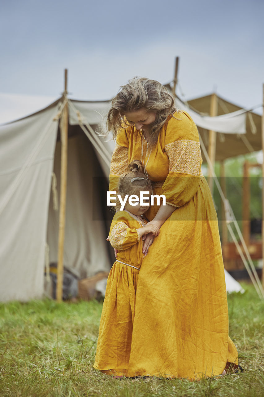 rear view of young woman sitting on tent