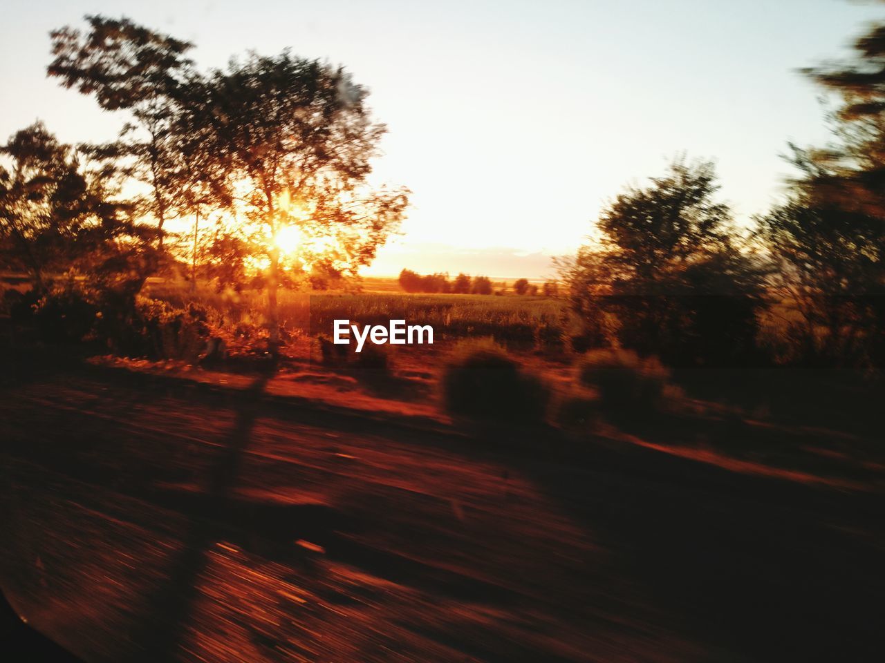 SCENIC VIEW OF SUNSET OVER FIELD