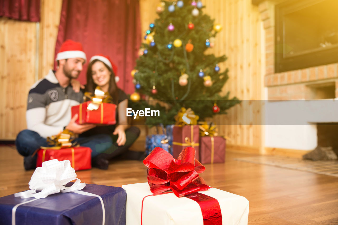 WOMAN WITH CHRISTMAS TREE IN BOX