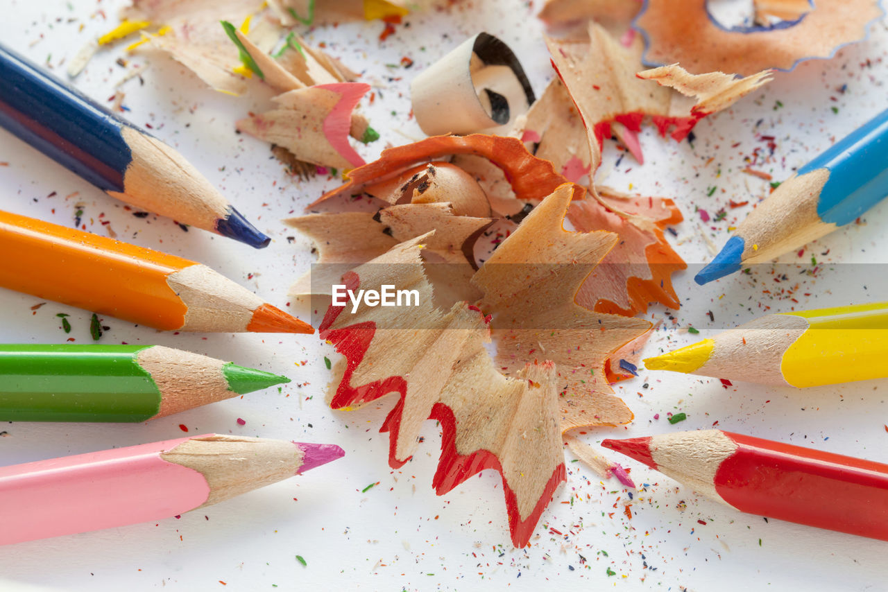 High angle view of multi colored pencils and shavings on table