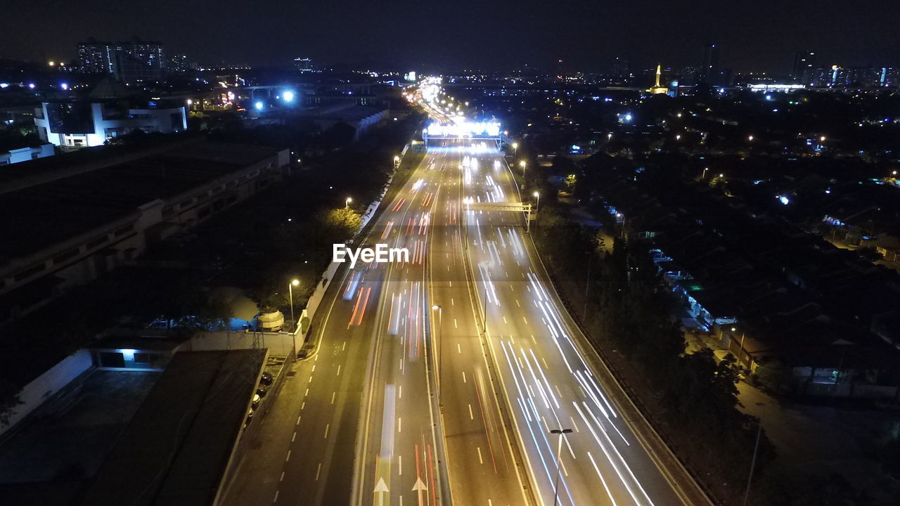 HIGH ANGLE VIEW OF LIGHT TRAILS ON ROAD IN CITY