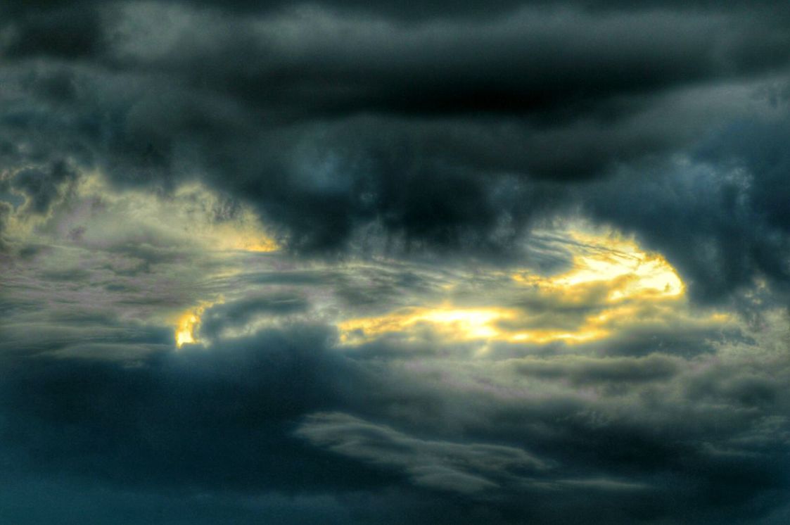 Low angle view of storm clouds in sky at sunset