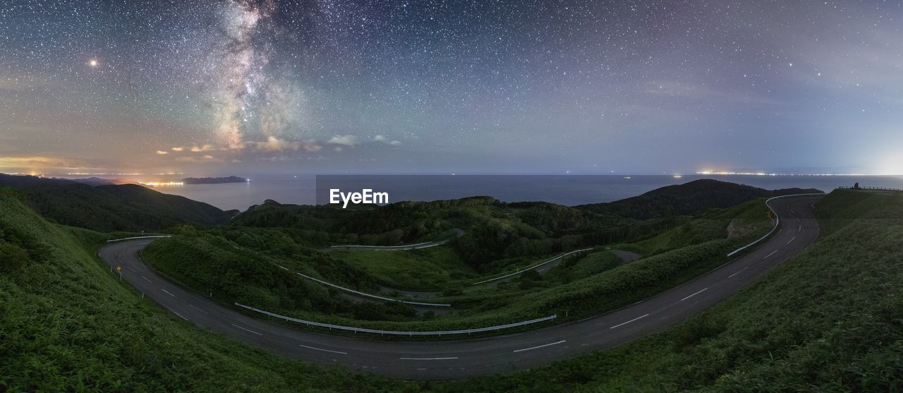 Panoramic view of landscape against sky at night