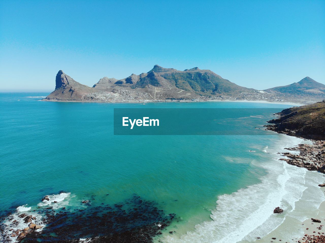 Scenic view of sea against clear blue sky