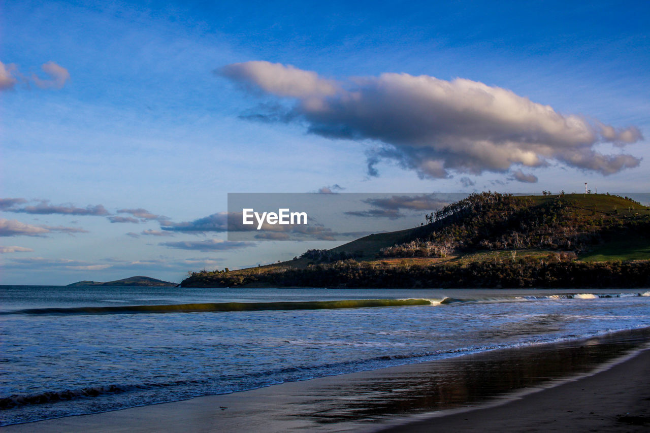 Scenic view of sea against cloudy sky