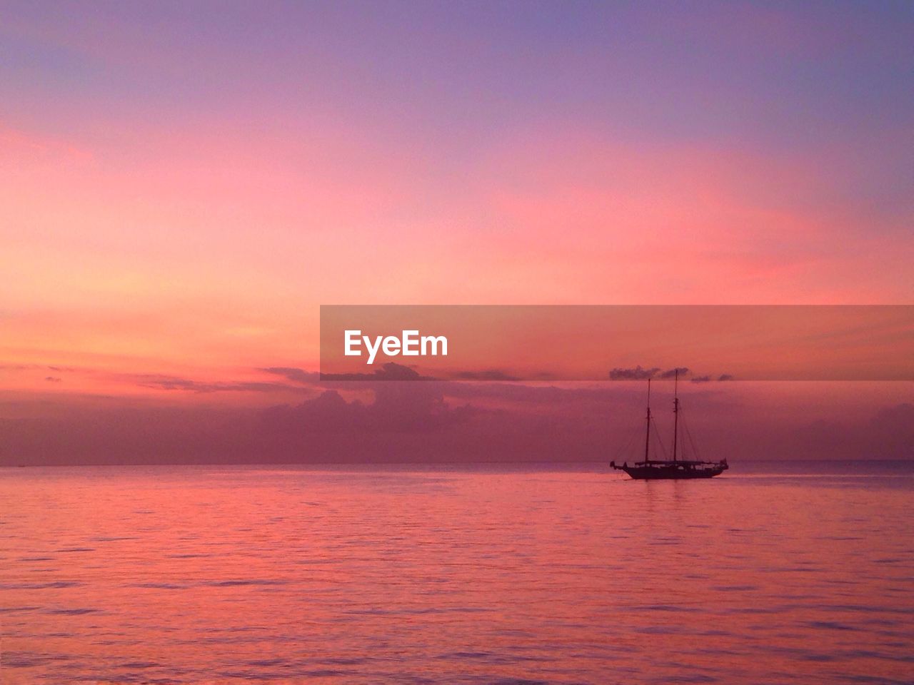 Scenic view of sea against romantic sky at sunset