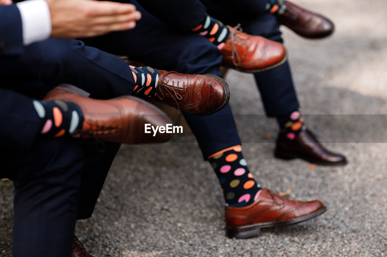 Stylish men's socks. stylish suitcase, men's legs, multicolored socks and new shoes. 