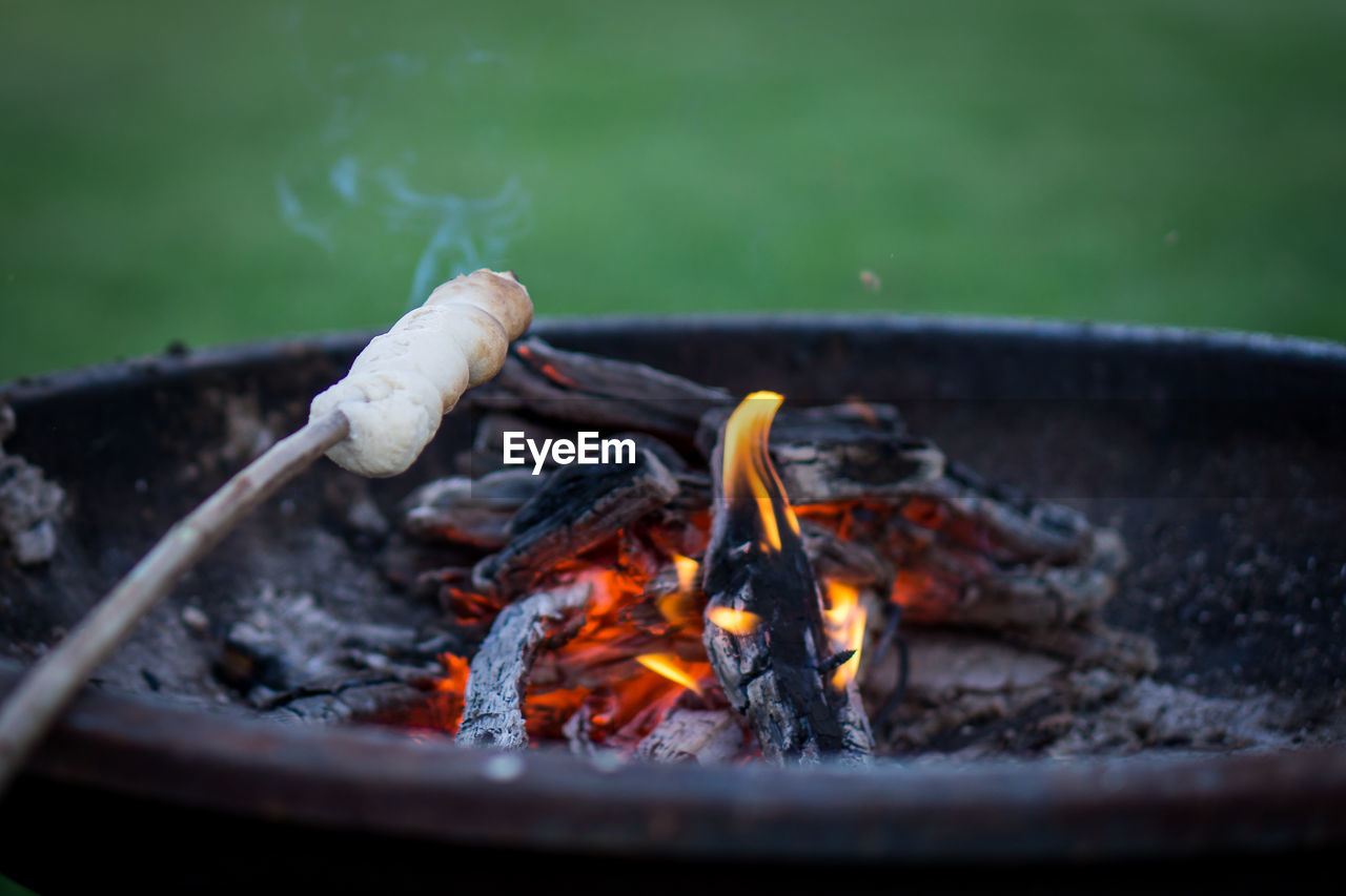CLOSE-UP OF BONFIRE ON BARBECUE GRILL