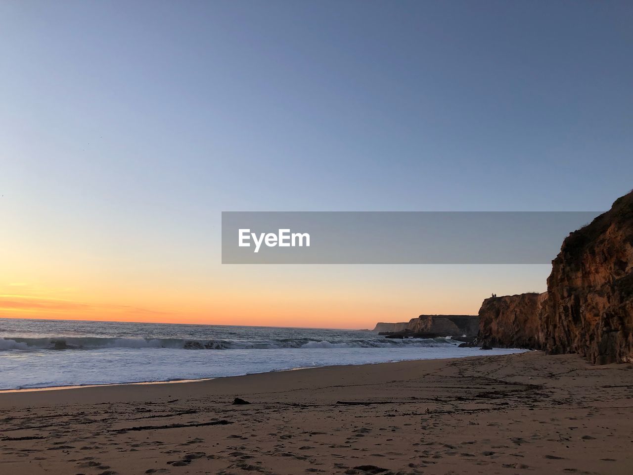 Scenic view of sea against clear sky during sunset