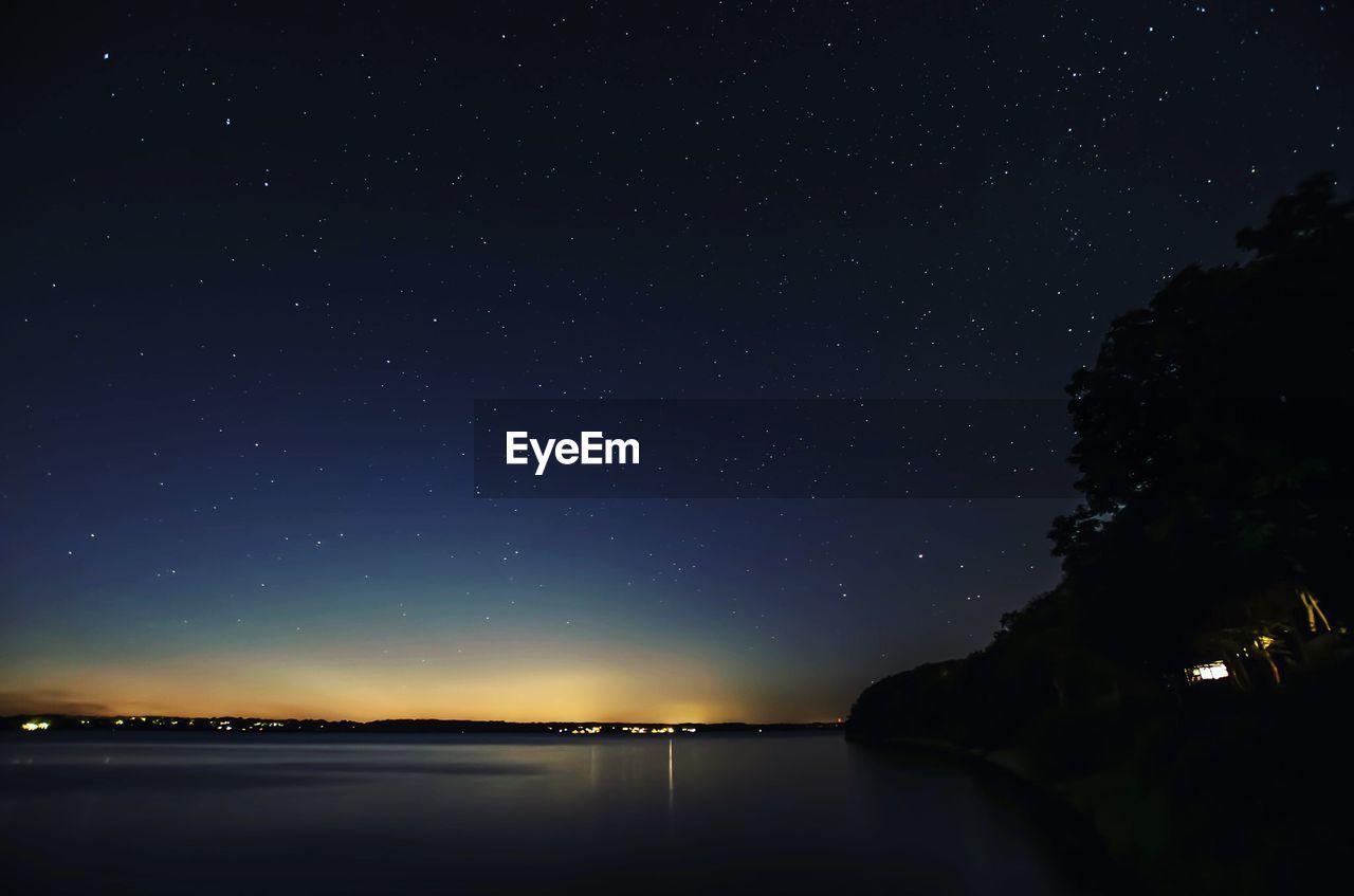 Lake against constellation during night