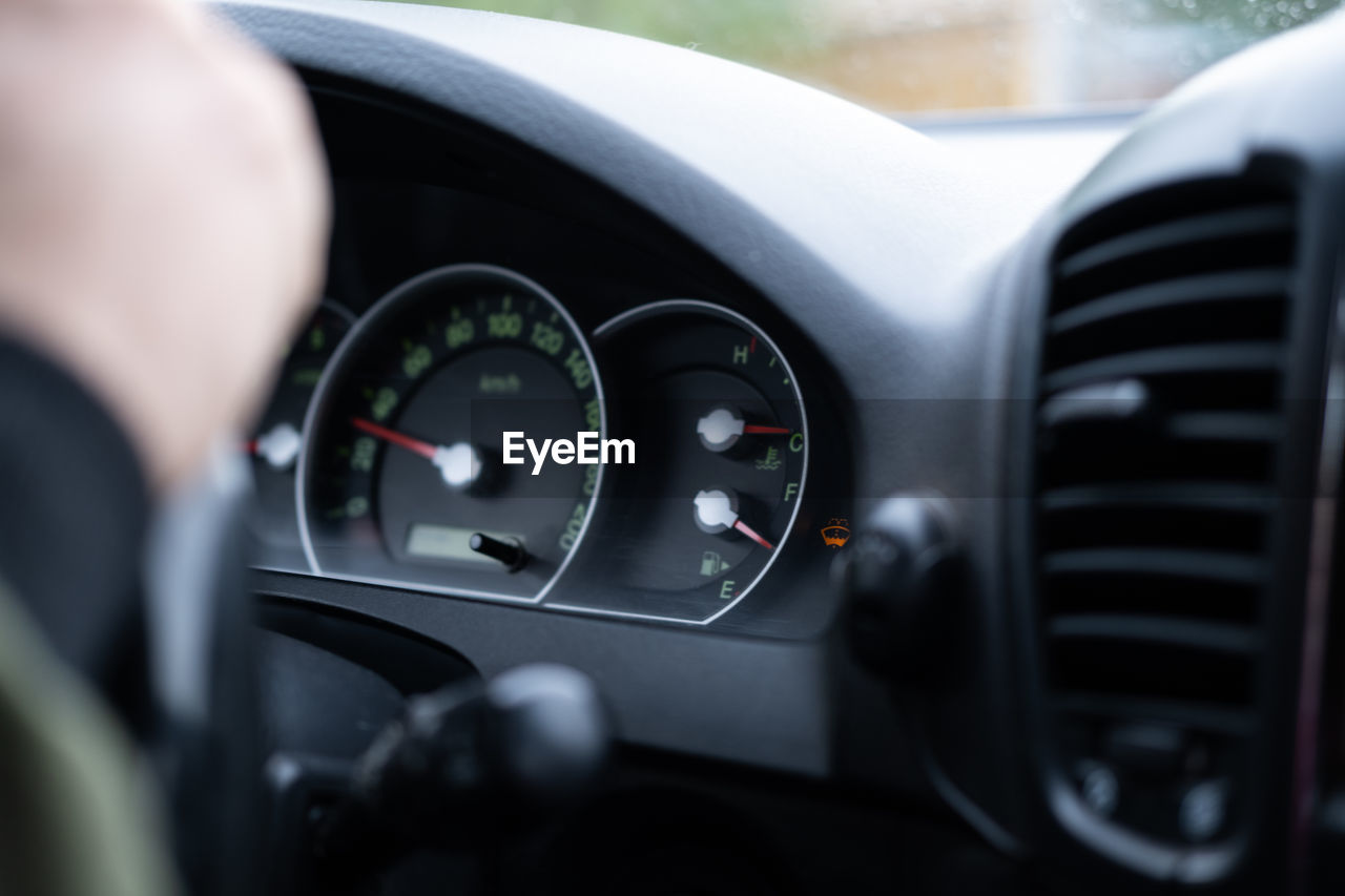 cropped hand of man using car